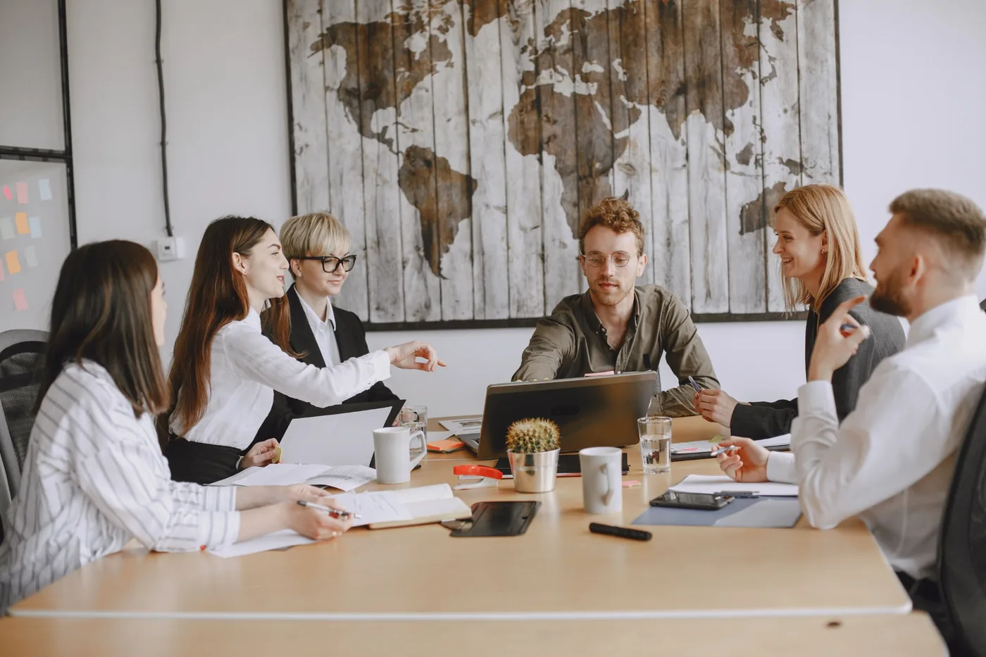 Team members discussing a project around a conference table